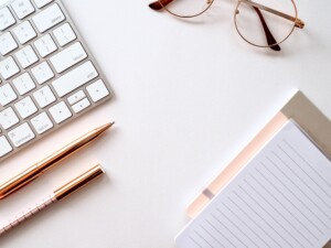 desk with computer and glasses